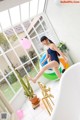 A woman in a bathing suit standing in a bathtub.