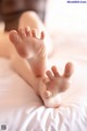 A close up of a baby's feet on a bed.